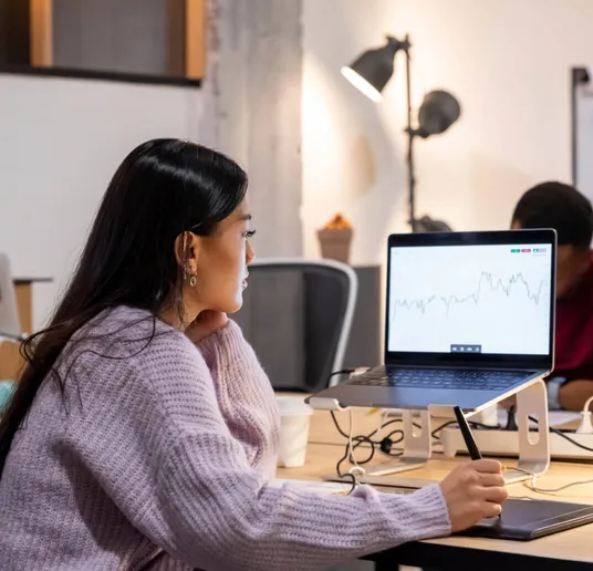 Image of woman watching on laptop